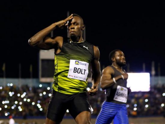 Jamaica's Olympic champion Usain Bolt (L) gestures after winning his final 100 meters sprint at the 2nd Racers Grand Prix at the National Stadium in Kingston, Jamaica June 10, 2017. REUTERS/Gilbert Bellamy