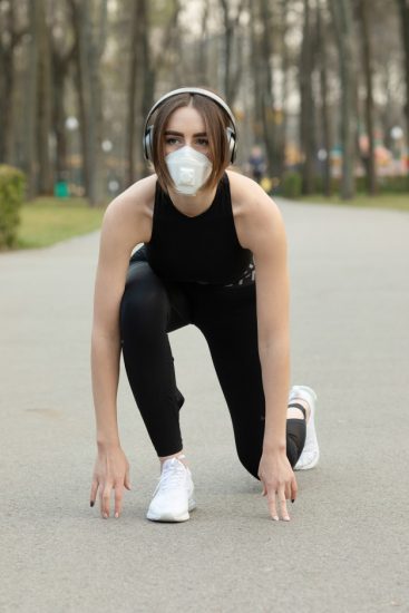portrait-caucasian-sporty-woman-wearing-medical-protection-face-mask-while-running-park-corona-virus-covid-19-is-spreading-all-world_137441-817