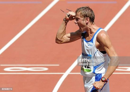 Italy's Alex Schwazer celebrates after crossing the finish line of the men's 50km walk ahead Australia's Jared Tallent and Russia's Denis Nizhegorodov at the National stadium as part of the 2008 Beijing Olympic Games on August 22, 2008. Alex Schwazer won the men's 50 kilometres walk gold medal in a new Olympic record of 3 hours 37 minutes and nine seconds. AFP PHOTO / WILLIAM WEST (Photo credit should read WILLIAM WEST/AFP via Getty Images)