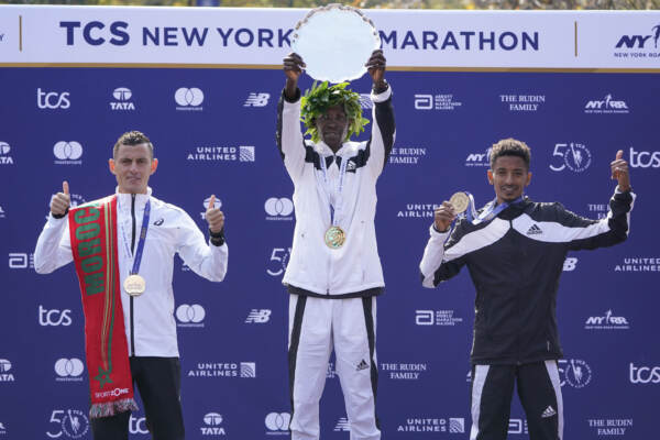 First place mens finisher Albert Korir of Kenya, center, second place finisher Mohamed El Aaraby of Morrocco, left, and third place finisher Eyob Faniel of Italy participate in a ceremony at the finish line of the New York City Marathon in New York, Sunday, Nov. 7, 2021. (AP Photo/Seth Wenig)